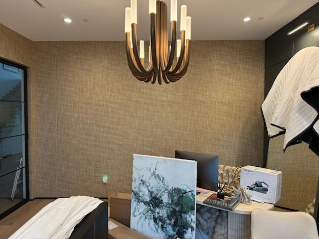 Neutral wallpaper and chandelier detail in a Maple Grove room near Weaver Lake